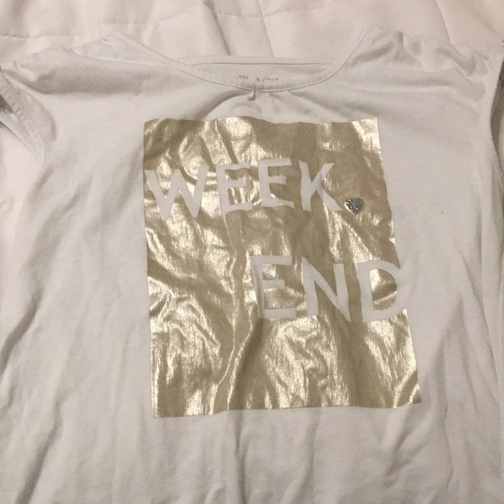 A white tee with a ties on the sleeves.
